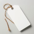 A pristine white blank tag with a natural twine tied through the hole, placed on a simple gray backdrop.