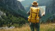 Explorer with Backpack Studying Map in Mountain Terrain