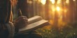 © xartproduction - A woman is sitting in a forest and writing in a book