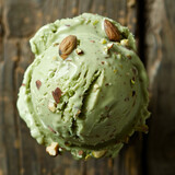 Fototapeta  - Pistachio Ice Cream with Almonds on Top. Scoop of pistachio ice cream sprinkled with almond pieces on a rustic wooden background, a gourmet dessert.