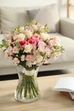 Fototapeta Koty - Beautiful bouquet of fresh flowers in vase on wooden table indoors
