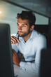 © peopleimages.com - Serious, thinking and businessman with pen by computer for email, internet and working late in office for corporate career. Happiness, desk and lawyer with technology for communication in workspace