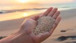 Arranges a hand holding sand that trickles between fingers, the warm beiges of the grains matching the subtle hues of the sunset in the background, expressing the fleeting nature of time