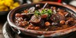 A hearty serving of Brazilian Feijoada, a rich stew with black beans, pork sausage, and garnished with fresh parsley