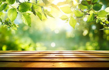 Wall Mural - spring - green leaves on wooden table in sunny defocused garden
