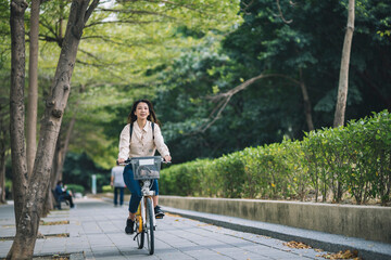 Asian woman renting shared bicycle in city