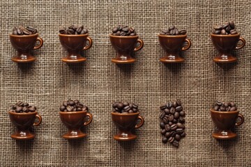 Wall Mural - A row of coffee cups with coffee beans in them