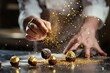 chef decorates truffles with gold dust
