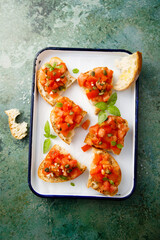 Wall Mural - Traditional tomato bruschetta with greens