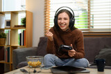 Fototapeta Nowy Jork - Happy young woman with joystick celebrating victory in online video game