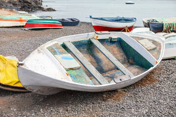 Wall Mural - Old wooden fishing boat on the coast. Vintage fishing vessel moored at the water's edge