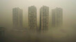 Aerial view urban cityscape with thick pm 2.5 pollution smog fog covering city high-rise buildings, yellow sky