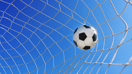 Wall Mural -  Soccer ball in soccer goal net in a big stadium isolated on blue sky. soccer net.