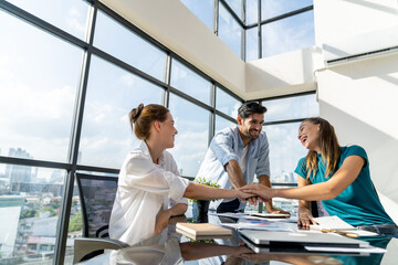 Group of skilled businesspeople putting hands together at modern office.Happy smart business team working together. Represented unity, love, team, working together, partnership, work place. Tracery.