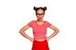 Strict teacher! Portrait of grimacing offended young gorgeous woman model with with hands on waist and bun hairstyle isolated on red background
