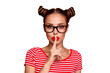 Shh! Portrait of attractive mysterious girl in glasses gesturing silence sign with forefinger red pout lips looking at camera isolated on red background