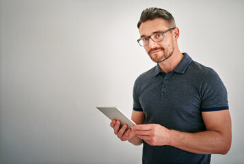 Canvas Print - Portrait, man and happy with tablet in studio on white background for ecommerce or network as technology specialist. Mature person, businessman and smile for digital communication and connection