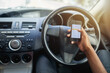 Phone, texting and driving with hands of person on steering wheel with scroll, danger and risk. Road safety, awareness and driver in car with smartphone, distraction and attention with auto insurance
