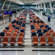 © Ionela - Empty ogange and blue seats in airport