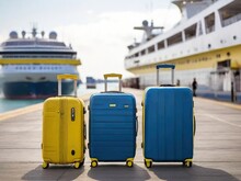 Yellow And Blue Suitcases Stand In Port As They Are Loading Onto Cruise Ship. Family Rest And Vacation Concept. High Quality