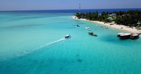 Beautiful view of boats in a calm sea with an island on a summer sunny day