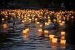 Goose families swimming in a pond with floating lanterns.