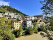 Beautiful traditional colorful houses with trees in Fossombrone , Italy on a summer day