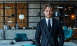 Professional businessman in formal attire standing near a sofa, AI-generated.