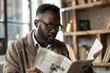 African man reading newspaper breaking fake news headline