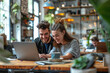 Young Couple Enjoying Coffee and Laptop at a Cafe