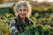 Elderly Woman Smiling in Her Lush Vegetable Garden