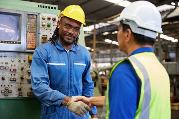 technician or engineer shaking hands with coworker before starting work in the factory