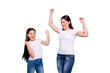 © deagreez - Close up photo cheer pretty two people brown haired mum small little daughter  arms up in air gladly yelling family games victory wear white t-shirts isolated bright blue background