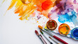 Colorful watercolor background with paintbrush and colorpots on white paper, copy space for text. Artistic creative design template. Watercolour painting. Color splashes, brush strokes. Flat lay