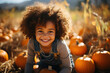 A young girl with a joyful expression among a field of pumpkins