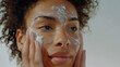 Skincare Elegance: Woman's Close-Up as She Applies Cleanser