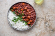 Plate with red beans and white rice on a beige granite background, horizontal shot with space, above view