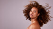 Afro, hair and portrait of black woman in mockup with confidence, pride and studio space. Natural haircare, curls and hairstyle on model with growth, style and keratin treatment with pink background