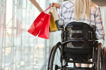 Independent shopping experience of a young woman using a wheelchair at a modern mall