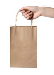 Wall Mural - Woman holding kraft paper bag on white background, closeup. Mockup for design