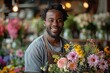 © Andrii Zastrozhnov - The florist, a cheerful owner, arranges flowers in his indoor flower shop, radiating confidence