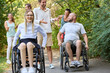 © Robert Kneschke - Inclusive group of friends enjoying a sunny day outdoors, with people using wheelchairs