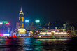 Skyline of the world famous international cityscape of Hong Kong with ferry lights in foreground