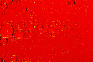 Wall Mural - Macro red soft drink background,abstract background. drops of oil on water, red and green color. macro