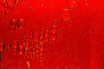 Wall Mural - Macro red soft drink background,abstract background. drops of oil on water, red and green color. macro