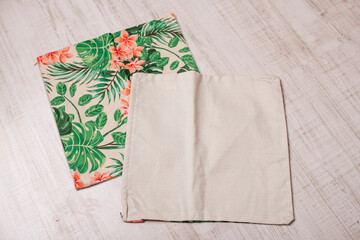 two decorative pillowcases with a tropical pattern