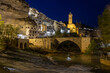 © MARIA ALBI - Alcalá del Júcar at night, located on a rock formed by the gorge of the Júcar River, cave houses roman bridge, castle, Church of San Andrés Apóstol (Albacete, Spain).