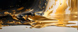 An artful splash of gold paint captured against a stark black background, symbolizing contrast