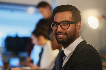 Business man, portrait and computer at night in office, online and software or web design. Male person, coworking space and typing code for deadline, cybersecurity and app developer or programmer