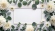 A rectangular frame decorated with eucalyptus leaves and white dahlias embodying a minimalist Boho chic style